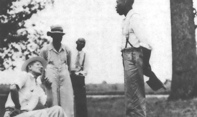 Black and white photo of men talking outside