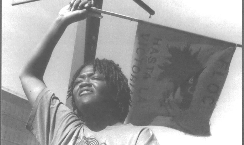 Black woman waving small flag