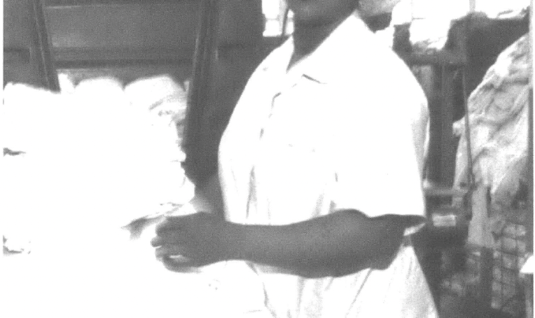 Line worker in hairnet, looking at the camera