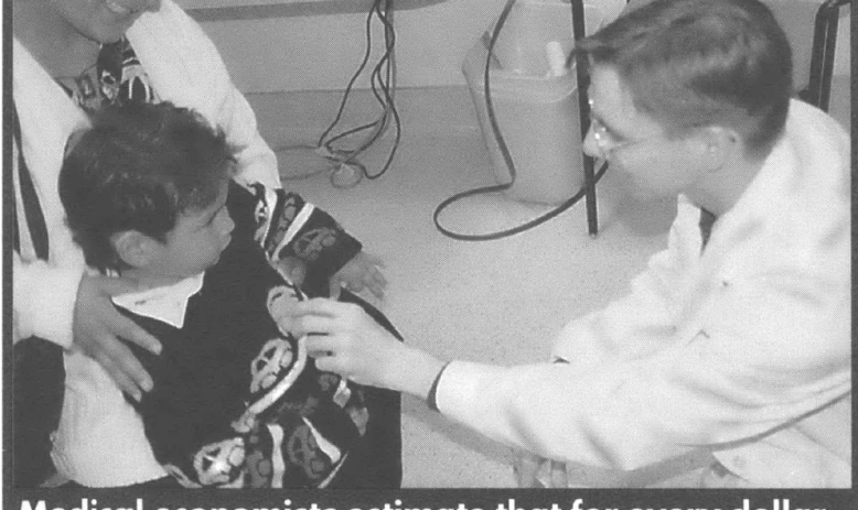 Doctor holding a stethoscope to a child's heart