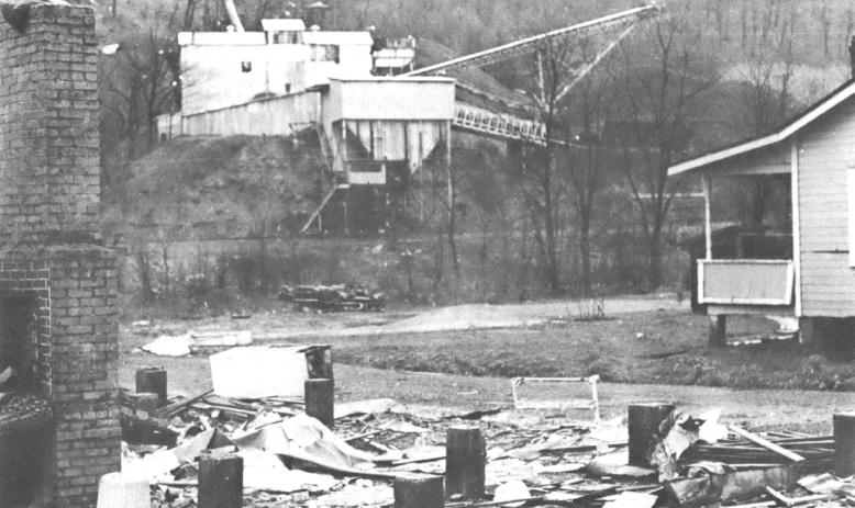 Black and white photo taken across the street from a mining facility