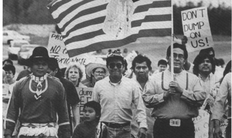 Black and white photo of group of marchers, mostly people of color
