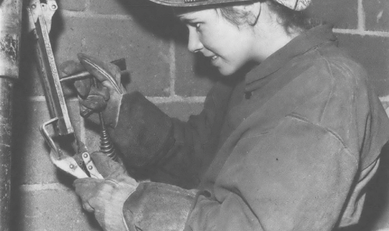 Black and white photo of woman welding