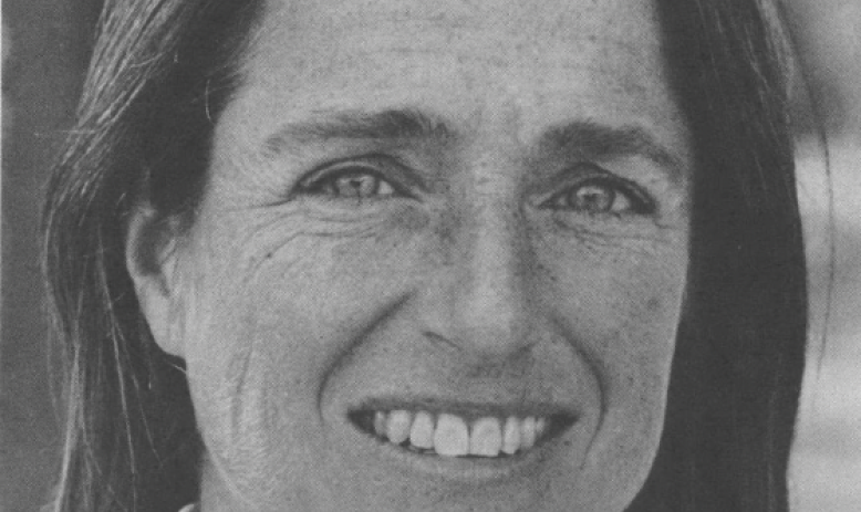 black and white photo portrait of white woman with hair down smiling at camera