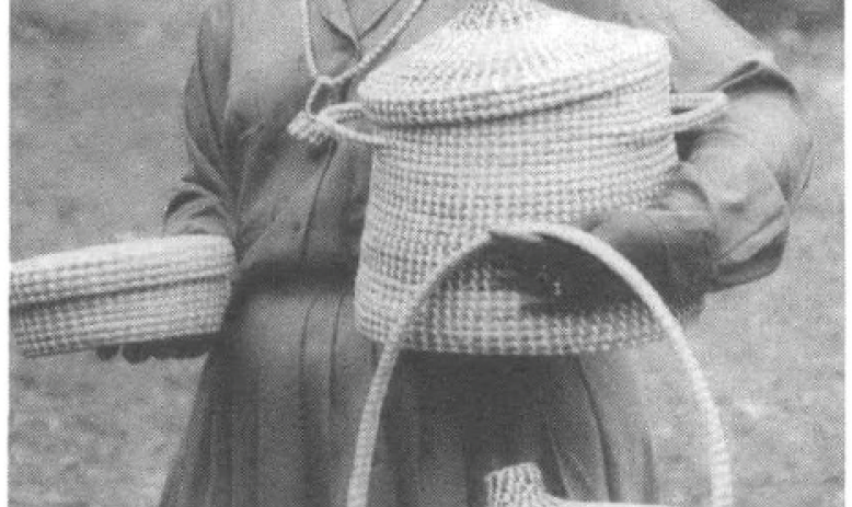Henrietta Spees holds baskets made by her grandmother, her mother, and herself