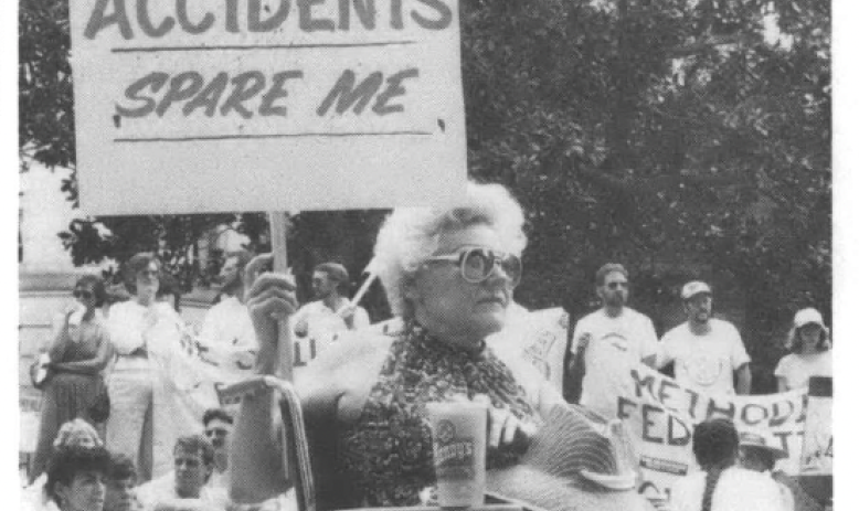 Protest against Shearon Harris nuclear plants, woman in wheelchair holding sign that reads Nuclear Accidents Spare Me
