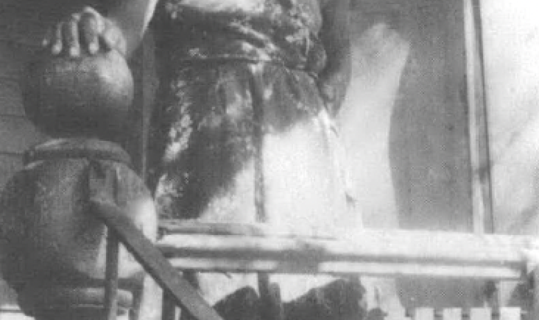 Black and white photo of Black woman standing on porch