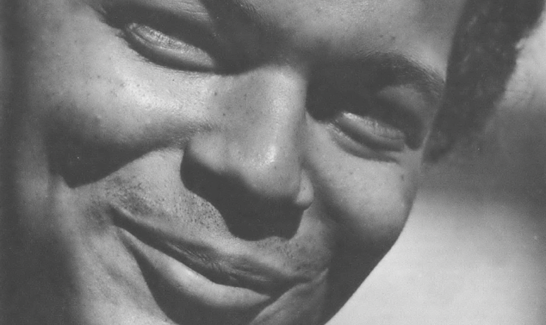 Black and white close-up photo of a young Black man, Julian Bond