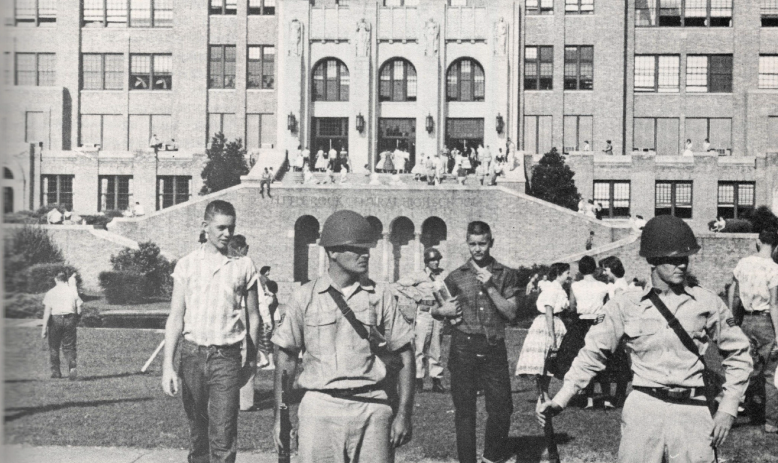 Black and white photo of National Guard and white students standing in front of Little Rock Central high school