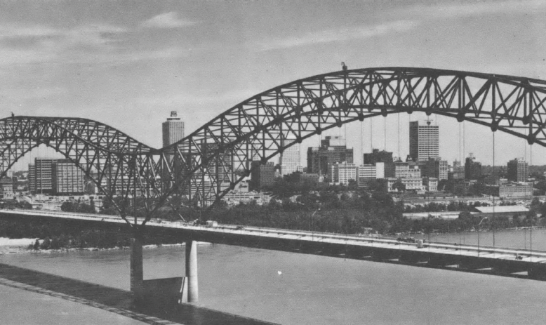Black and white photo of large bridge over river