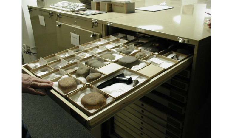 An open drawer of stone-like objects in the Research Center of the North Carolina Office of State Archaeology.