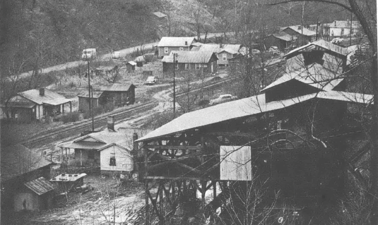 Black and white aerial shot overlooking valley community with many homes