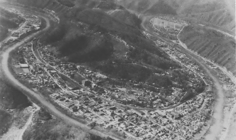 Black and white aerial view of some homes and small town 