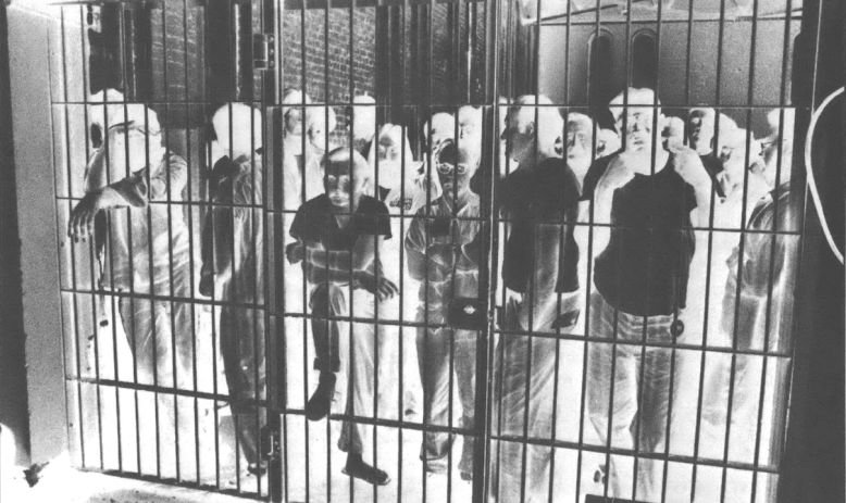 Photo negative of a group of people in a cell