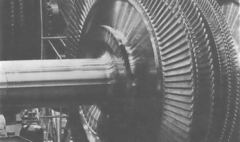 Black and white photo of large machinery inside building 