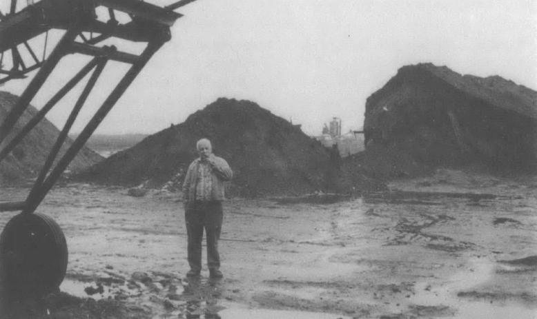 man standing in peat field