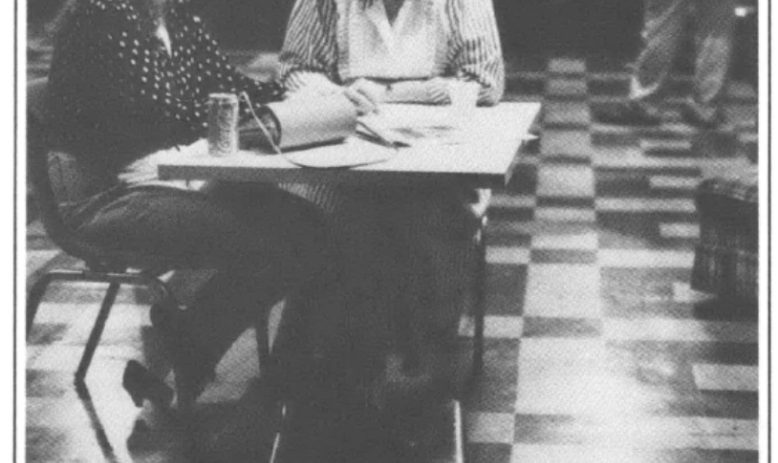 two women sitting and talking