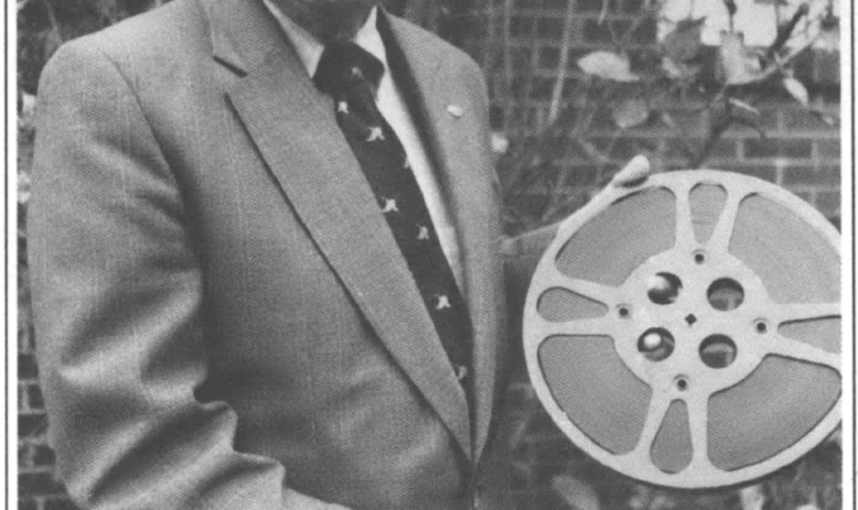 Norman Pinkelton holding a film reel