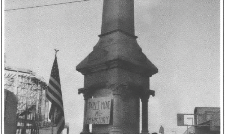 supports of KKK rally around city monument