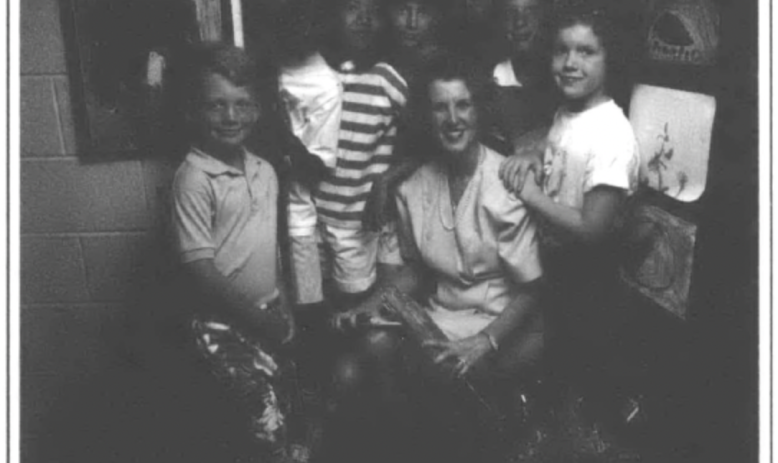 photograph of teacher and students