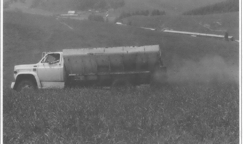 a poultry farms spread chicken manure on his pasture