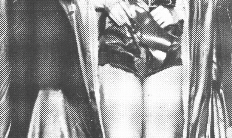 Black and white photo of woman in basketball uniform holding a bouquet of flowers