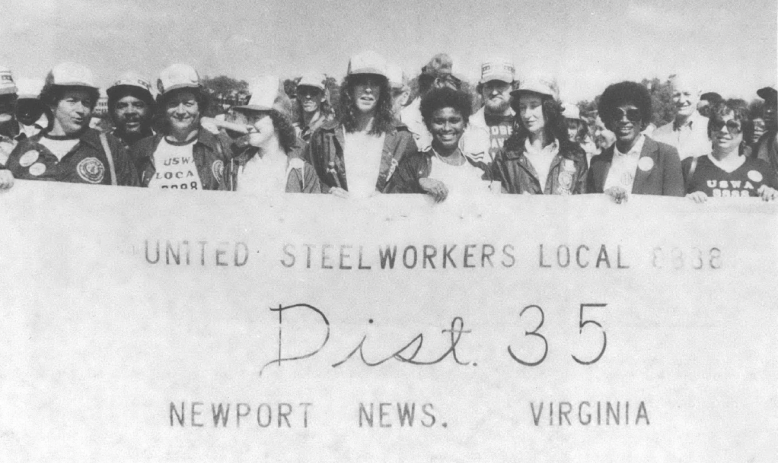 Black and white photo of women holding United Steelworkers banner