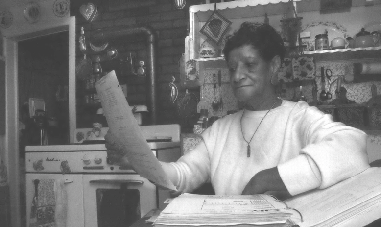 Woman reviews documents in her kitchen