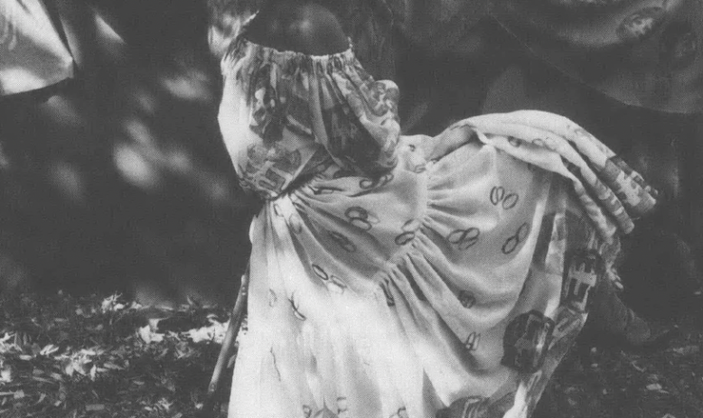 Black and white photo of girl in dress and sun hat