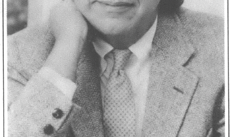 Headshot of man with hand in chin 
