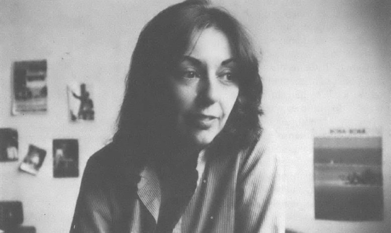 Black and white portrait of young white woman with long hair looking away from the camera