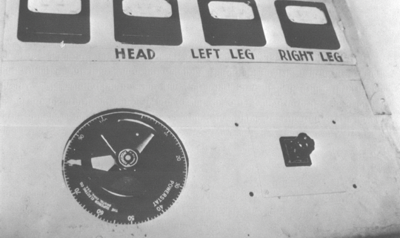 Black and white photo of machine with buttons reading"head," "left leg," "right leg"