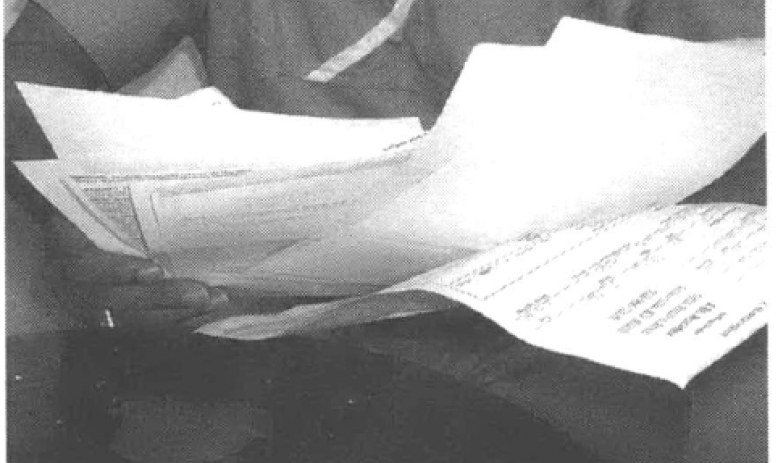 Man holding a bunch of documents