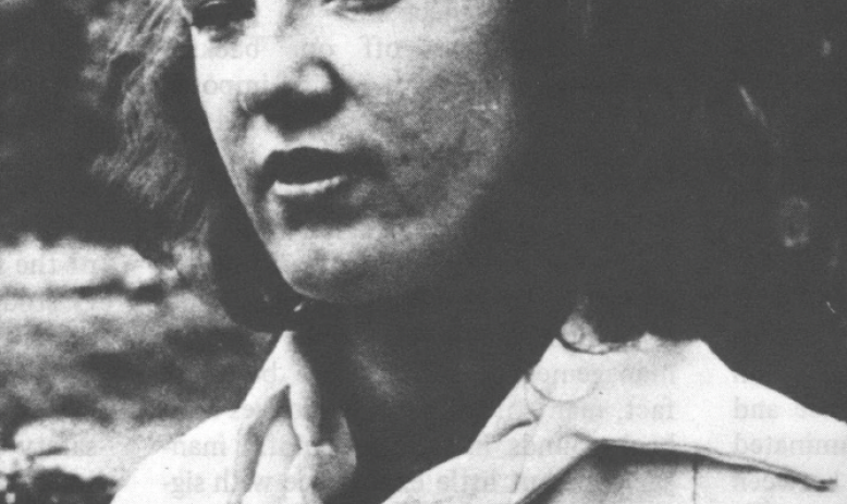 Black and white photo of young white woman in some kind of uniform talking