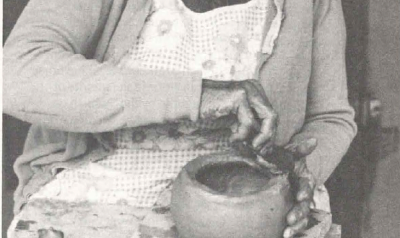 Old woman working a clay pot