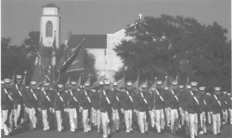 Rows of students in military uniforms in front of university building