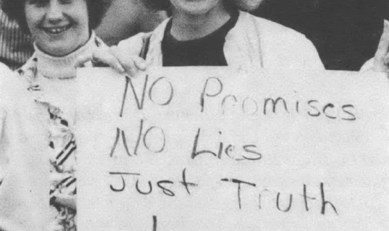 Black and white photo of young woman holding side reading "No Promises No Lies Just Truth Levis"