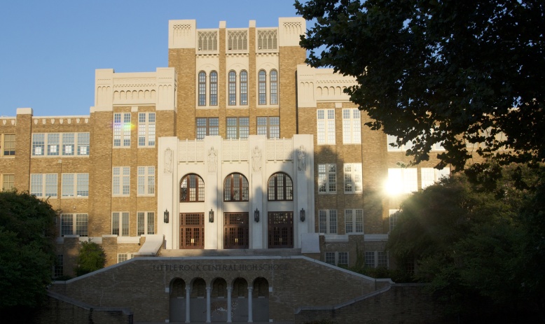 Front-facing photograph of old school buildling with stairs in front and lettering reading "Little Rock Central High School"