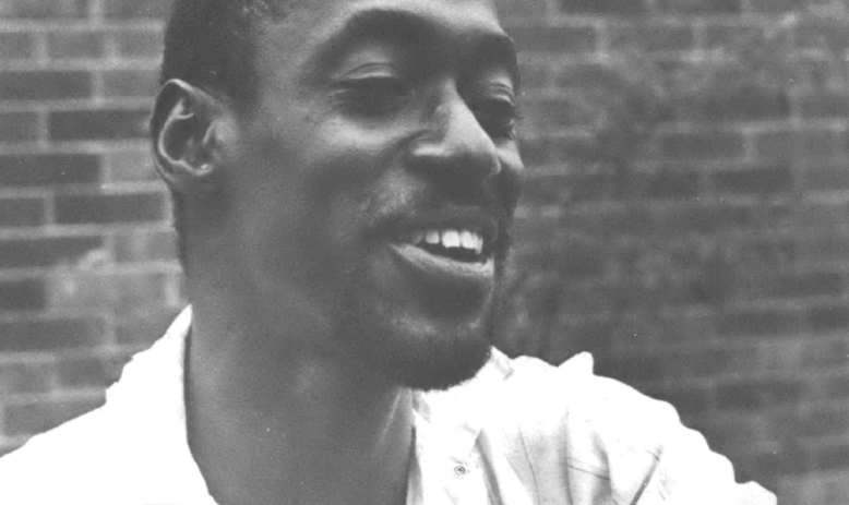 Headshot photo of Black man laughing