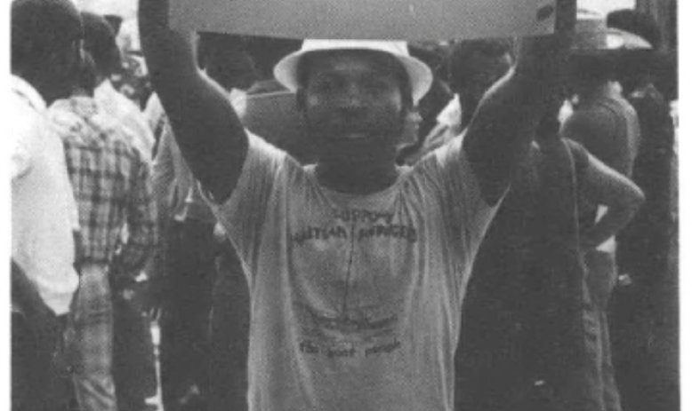 Haitian man holding sign at demonstration outside Miami's Krome Detention Center