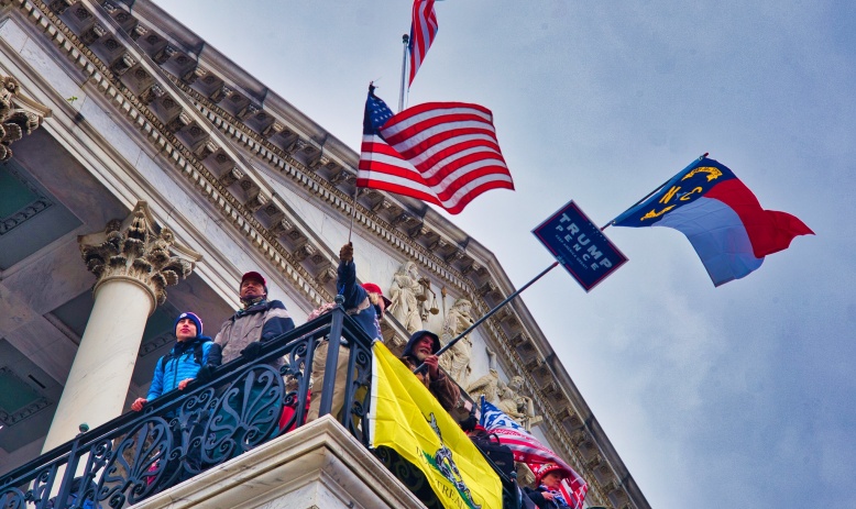 Rioters at the U.S. Capitol wave the American flag, the North Carolina state flag, and others on Jan. 6, 2021 