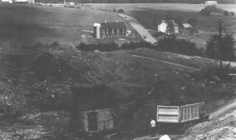 Land in the mountains with machinery in the foreground