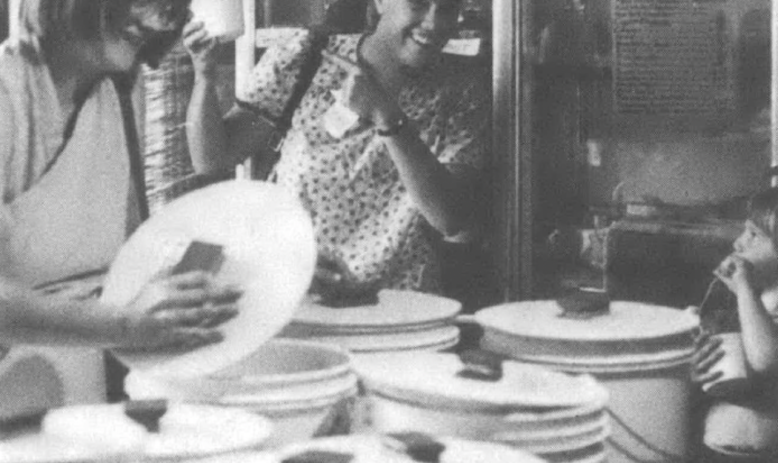 two women smiling and opening buckets