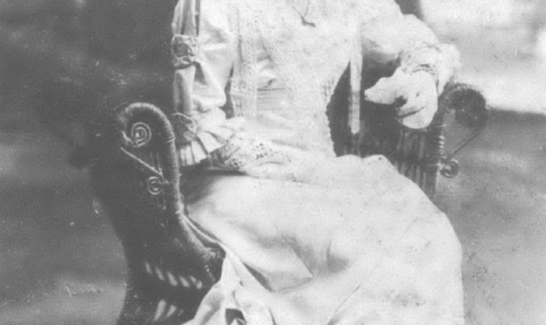 portrait of Black woman sitting in chair looking down