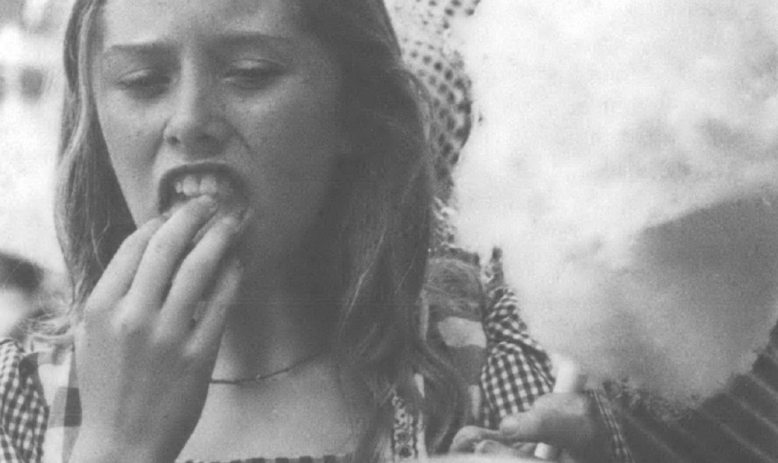 a girl eating cotton candy