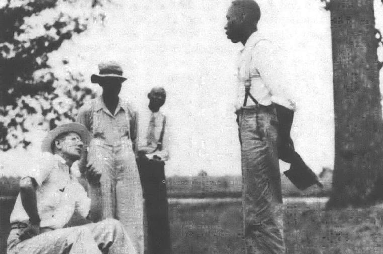 Black and white photo of men talking outside