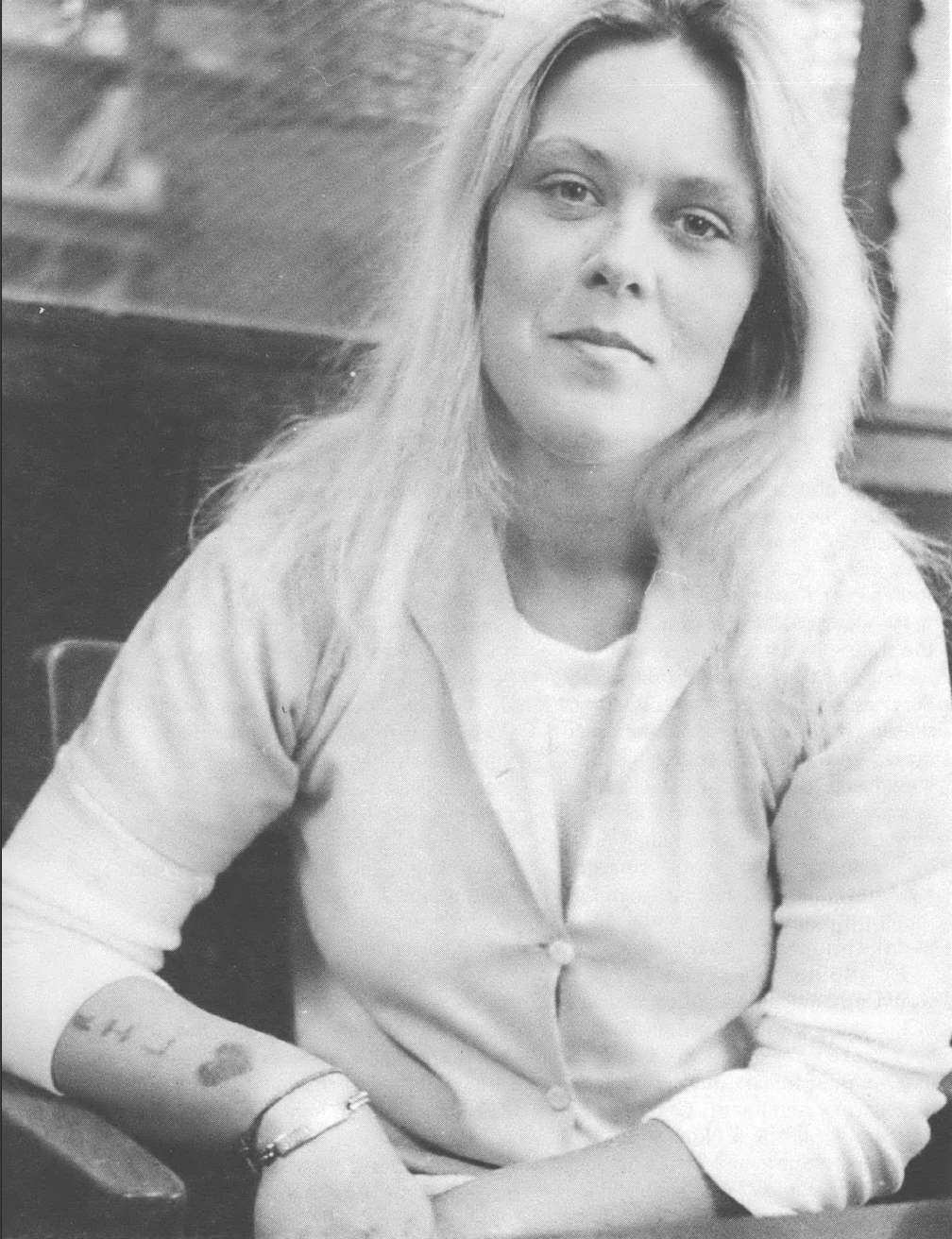 Black and white casual photo of young white woman looking at camera