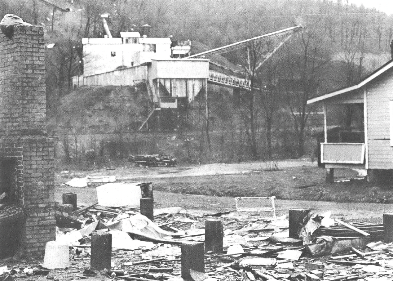 Black and white photo taken across the street from a mining facility