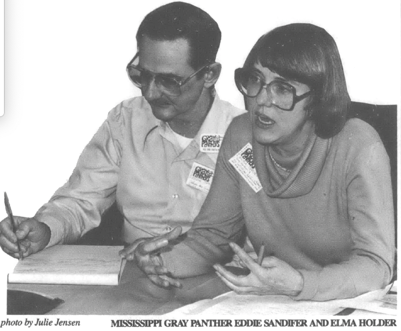 Photo cutout of two white people, a man and a woman. The man is taking notes while the woman is speaking