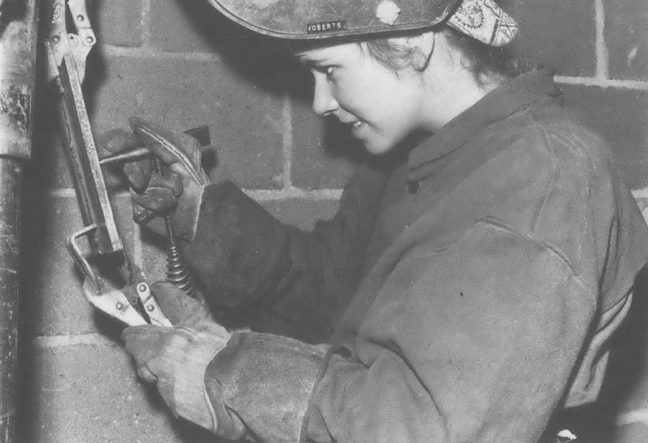 Black and white photo of woman welding